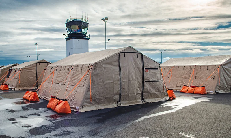 A deployed DLX ASAP rapid-deployment shelter set up in the field